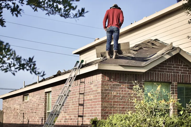 Professional roofer working on a residential roof in West Orange